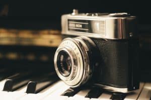 Photograph of 35mm camera on piano keys