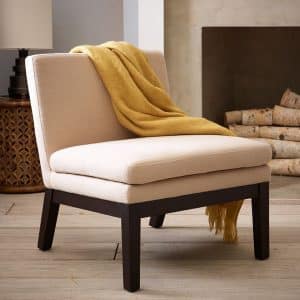 Photo of white chair with yellow blanket draped across back